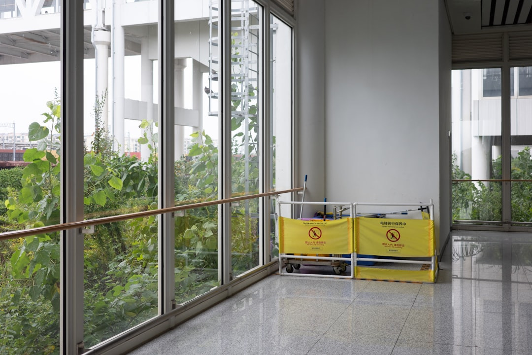 Maintenance carts parked in a bright modern office corridor.